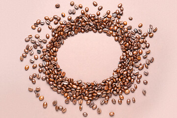 Frame made of coffee beans on beige background