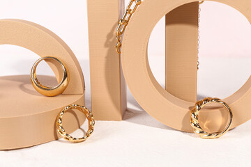 Decorative podiums with beautiful jewelry on white background