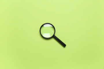 Black mini magnifier on green background
