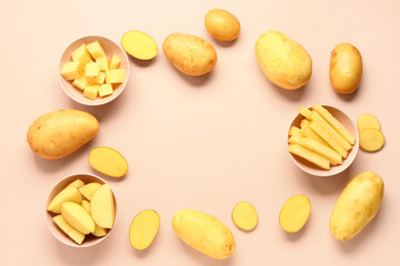Frame made of cut and whole potatoes on pink background