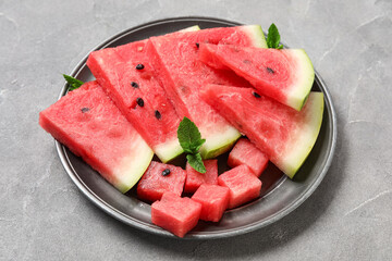 Plate with pieces of ripe watermelon on grey background, closeup