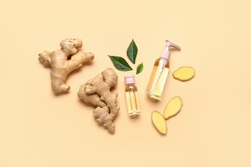 Bottles of ginger cosmetic oil and leaves on yellow background