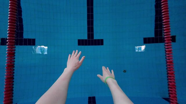 Swimmer girl start from the starting table in the pool. Point of View. Slow motion.