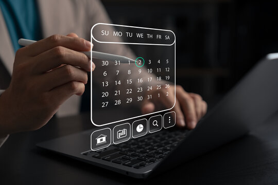 Businessman using digital calendar interface on laptop with stylus pen, representing time management, event scheduling, productivity planning, online appointments, and digital organization.