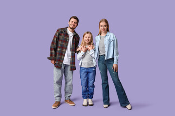 Fototapeta premium Happy family in stylish denim clothes on purple background