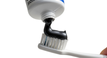 Black Toothpaste Extruding onto a Toothbrush Oral Hygiene Concept