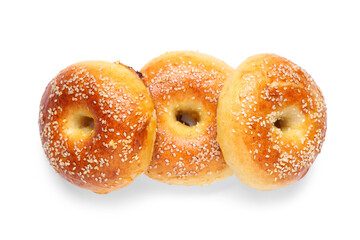 Tasty bagels with sesame seeds on white background