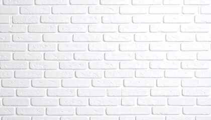 Fototapeta premium An even arrangement of white painted bricks creates a clean and textured wall surface effect.