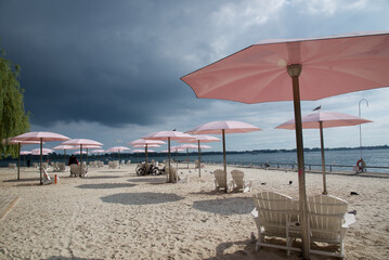 A serene view of a pink beach umbrellas, perfect for relaxation and summer vibes