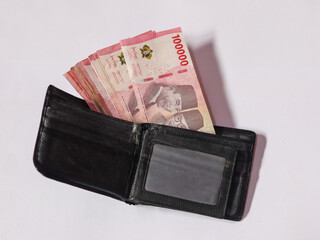 100 thousand Indonesian rupiah money and wallet