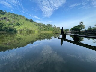 The beautiful Claket Lake reflects hills and clouds like a mirror. Its calm, clear water creates a stunning scene, blending sky and nature in perfect harmony.
