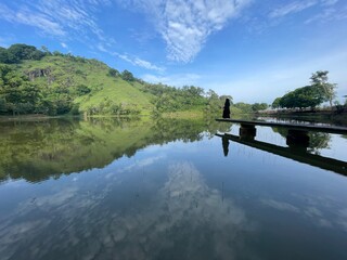 The beautiful Claket Lake reflects hills and clouds like a mirror. Its calm, clear water creates a stunning scene, blending sky and nature in perfect harmony.