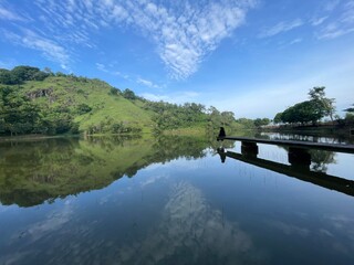 The beautiful Claket Lake reflects hills and clouds like a mirror. Its calm, clear water creates a stunning scene, blending sky and nature in perfect harmony.