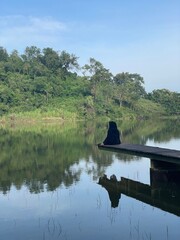 The beautiful Claket Lake reflects hills and clouds like a mirror. Its calm, clear water creates a stunning scene, blending sky and nature in perfect harmony.