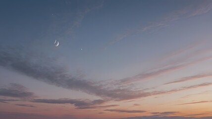 Serene sky at dusk with crescent moon and scattered clouds, creating a peaceful evening scene

