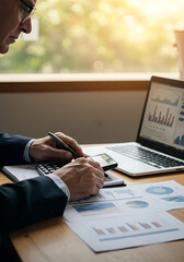 Focused Analysis: A skilled professional meticulously reviews financial data, utilizing technology and traditional methods to make precise calculations and insightful interpretations.