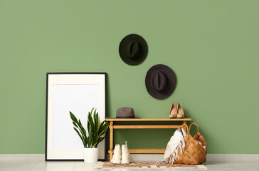 Interior of hallway with stylish hats and bench