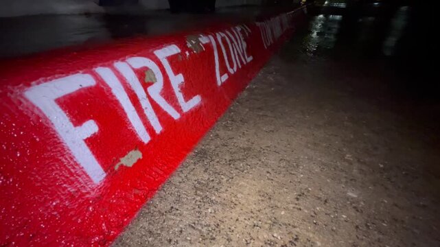 Fire Zone curb with water flowing over it 