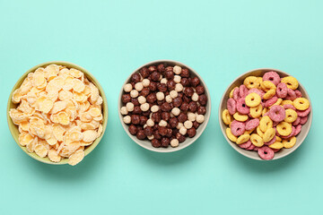 Composition with bowls of different tasty cereals on turquoise background