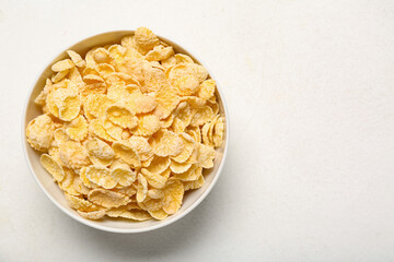 Bowl with tasty cornflakes on white background, closeup