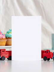 Blank White Greeting Card with Red and Blue Train Toys and Cupcakes in Soft Bakery Background