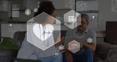 Physician entering room tapping tablet beside patient and animating medical icons showing vitals