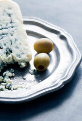 Blue Cheese with Green Olives on Silver Plate