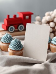 Blank White Greeting Card with Red and Blue Train Toys and Cupcakes in Soft Bakery Background