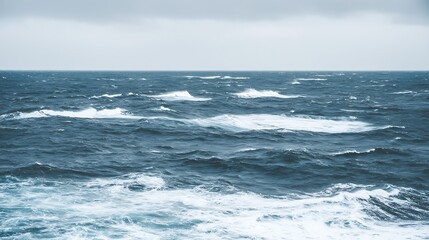 Turbulent ocean surface under cloudy sky