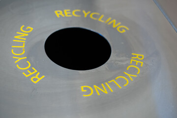 recyling bin, with a circular opening for bottles and cans