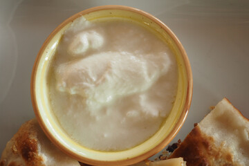 Delicious yogurt served with crispy bread on a plate