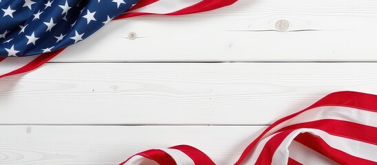 American flag ribbons draped over a rustic white wooden surface.