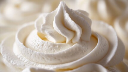 Close up of a luxurious swirl of whipped cream perfectly smooth and airy elegantly plated on a dessert