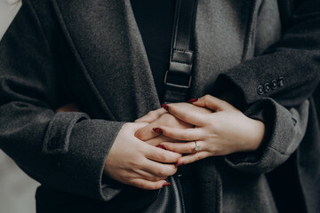 Newly engaged couple's hands. Fiance hugs fiancee