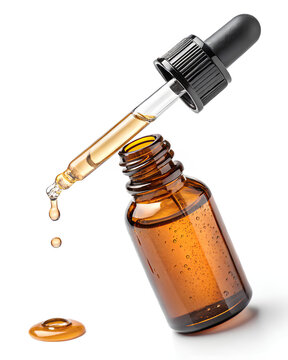 Glass amber dropper bottle dispensing oil, commonly used for essential oils, skincare serums, or natural remedies on white background.
