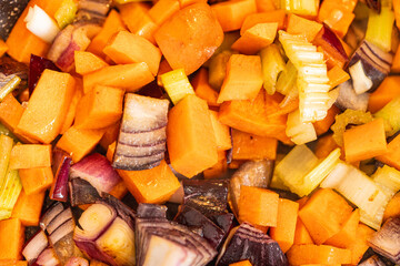 Vegetables are fried in a pan. Carrots, celery and onions are sauteed. The process of preparing ingredients for a dish. Background., close-up, selected focus. High quality photo