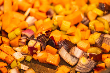 Vegetables are fried in a pan. Carrots, celery and onions are sauteed. The process of preparing ingredients for a dish. Background., close-up, selected focus. High quality photo