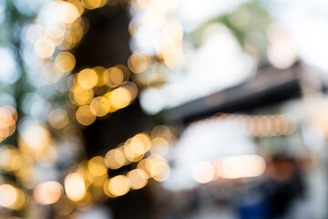 Close up unfocused lights in the shape of circles of colors outdoors, wallpaper of light orange and...