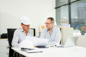 Engineers are discussing data working and laptop or tablet with architectural project at new construction site