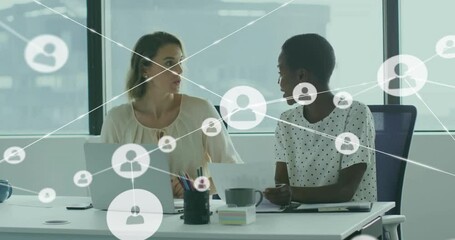 Businesswomen at desk scrolling laptop and taking notes, growing user nodes and ending high-fiving - Powered by Adobe