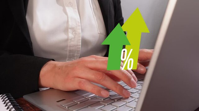 Close-up of a woman's hands typing on a laptop, wearing a white shirt and black jacket. A green arrow pointing upwards with the text "%" above it, suggesting a concept for business growth or financia