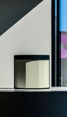 Cream-colored jar on shelf, shadows