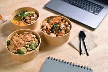 Having a lunch break at the office with delicious Healthy food delivery in take away boxes, Healthy eating concept.