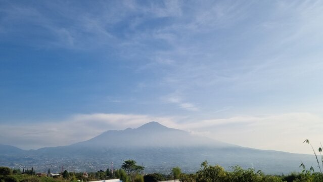 Scenic view of Mount Arjuno Welirang in Batu, Indonesia. The second highest mountain in East Java. Scenic mountain landscape with soft morning mist and colorful sky. Beautiful nature view. For travel 