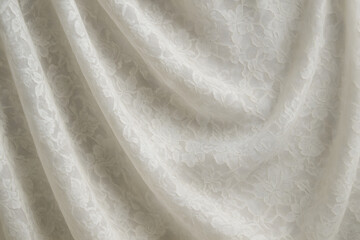 Creamy Draped Fabric: Elegant off-white fabric with subtle embossed pattern, softly draped to create flowing curves and textures.  Perfect for background or design element. 
