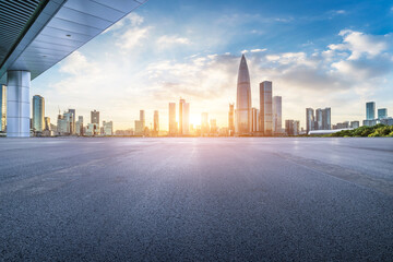 Asphalt road square and city skyline with modern buildings scenery at sunset in Shenzhen, China.