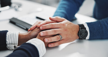 Doctor, patient and holding hands for comfort of bad news, diagnosis and treatment advice. Medical worker, support and consoling person with terminal illness, recovery problem and healthcare services