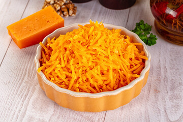 Yellow shredded cheddar cheese in the bowl