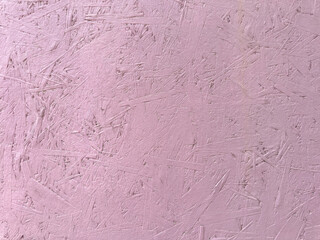 Pink paint cracks on wood surface. texture of painted pressed wood