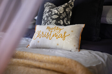 decorative cushion with Merry Christmas in a cursive font